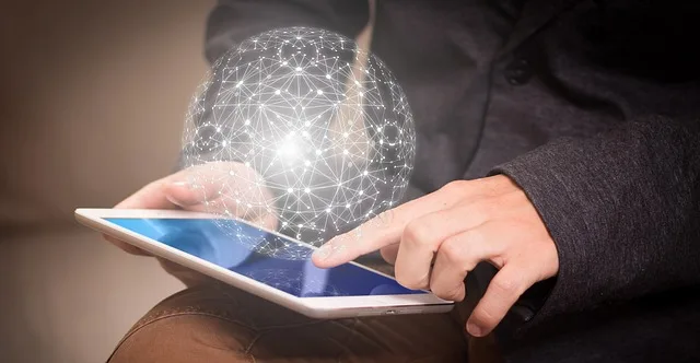 Person holding a tablet with one hand posed to press finger on screen. A sphere shape made of light dots connected by many lines floats over the tablet. (suggesting starting a new business or entity)